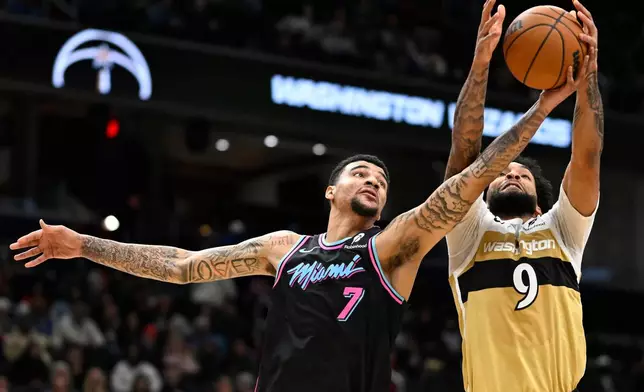 Miami Heat center Kel'el Ware (7) competes for a rebound against Washington Wizards forward Justin Champagnie during the first half of an NBA basketball game, Sunday, Feb. 8, 2026, in Washington. (AP Photo/John McDonnell)