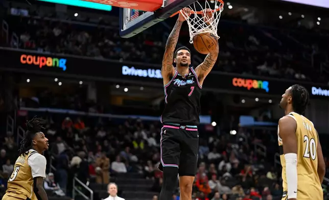 Miami Heat center Kel'el Ware (7) dunks during the second half of an NBA basketball game against the Washington Wizards, Sunday, Feb. 8, 2026, in Washington. (AP Photo/John McDonnell)