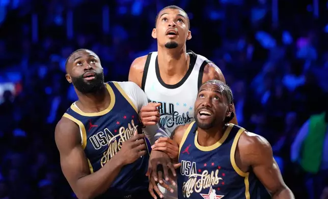 World center Victor Wembanyama, of France, vies for position under the basket next to USA Stripes guard Jaylen Brown, left, and forward Kawhi Leonard during the NBA All-Star basketball game Sunday, Feb. 15, 2026, in Inglewood, Calif. (AP Photo/Mark J. Terrill)