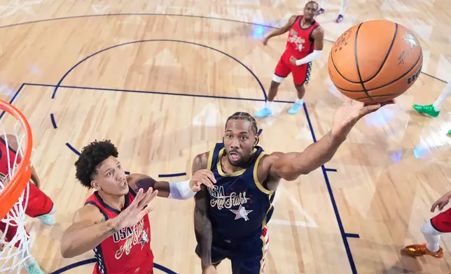 USA Stripes forward Kawhi Leonard (2) shoots past USA Stars guard Jalen Johnson in the NBA All-Star basketball game Sunday, Feb. 15, 2026, in Inglewood, Calif. (Ronald Martinez/Pool Photo via AP)