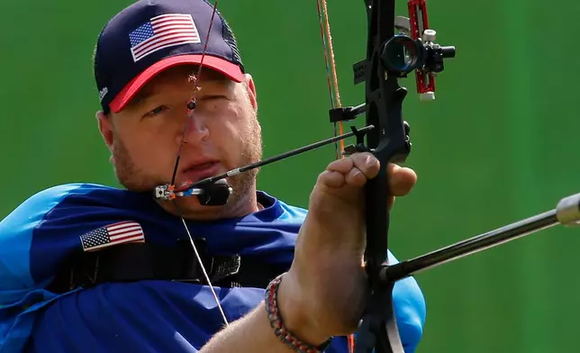 FILE - Matt Stutzman, of the United States, holds the bow with his foot as he competes in the individual compound-open, during the Paralympic Games at the Sambadrome, in Rio de Janeiro, Brazil, Sept. 14, 2016. (AP Photo/Silvia Izquierdo, File)