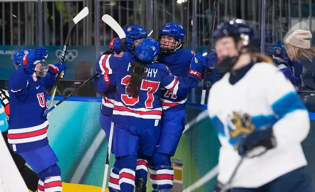 United States' Taylor Heise, 2nd right, celebrates with teammates after scoring her sides second goal during a preliminary round match of women's ice hockey between the United States and Finland at the 2026 Winter Olympics, in Milan, Italy, Saturday, Feb. 7, 2026. (AP Photo/Petr David Josek)