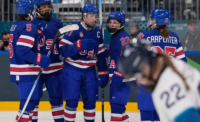 United States' Hilary Knight celebrates with teammates after scoring her sides fourth goal during a preliminary round match of women's ice hockey between the United States and Finland at the 2026 Winter Olympics, in Milan, Italy, Saturday, Feb. 7, 2026. (AP Photo/Petr David Josek)