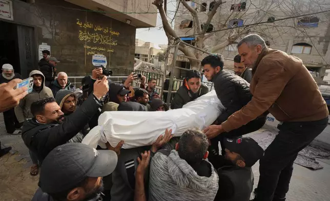 Mourners carry the bodies of two members of Hamas, Muhammad Abu Jabal, and Fadl Al-Burdini who were killed in an Israeli military strike, at Shifa Hospital in Gaza City Thursday, Feb. 26, 2026. (AP Photo/Jehad Alshrafi)