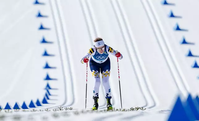 Ebba Andersson, of Sweden, approaches the finish line to win the gold medal in the cross country skiing women's 50km mass start classic at the 2026 Winter Olympics, in Tesero, Italy, Sunday, Feb. 22, 2026. (AP Photo/Matthias Schrader)