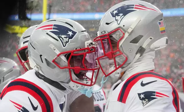 New England Patriots cornerback Carlton Davis III and cornerback Christian Gonzalez celebrate their win after the AFC Championship NFL football game against the Denver Broncos, Sunday, Jan. 25, 2026, in Denver. (AP Photo/Garrett W. Ellwood)