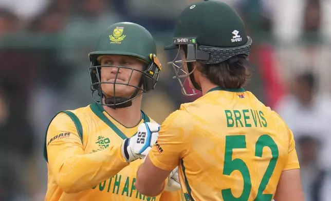 South Africa's Ryan Rickelton and South Africa's Dewald Brevis celebrate during the T20 World Cup cricket match between South Africa and United Arab Emirates in New Delhi, India, Wednesday, Feb. 18, 2026. (AP Photo/Manish Swarup)