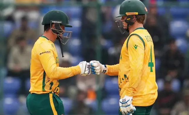 South Africa's Quinton de Kock and Ryan Rickelton celebrate during the T20 World Cup cricket match between South Africa and United Arab Emirates in New Delhi, India, Wednesday, Feb. 18, 2026. (AP Photo/Manish Swarup)