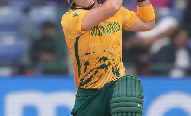 South Africa's Dewald Brevis hits a six during the T20 World Cup cricket match between South Africa and United Arab Emirates in New Delhi, India, Wednesday, Feb. 18, 2026. (AP Photo/Manish Swarup)