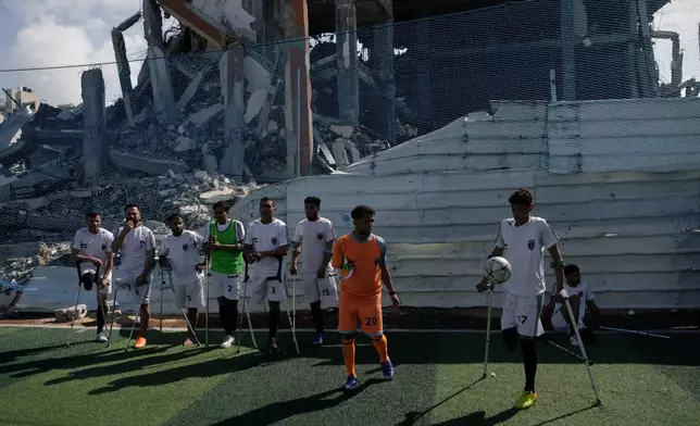 Palestinian amputee soccer players train on a newly built field surrounded by buildings destroyed in Israeli army bombardments during the Israel-Hamas war, in Gaza City, Wednesday, Feb. 11, 2026. (AP Photo/Jehad Alshrafi)