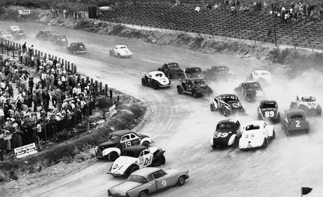FILE - Cars take a turn during the first lap of a NASCAR Sportsman's stock car auto race inn Daytona Beach, Fla., Feb. 24, 1954. (AP Photo, File)