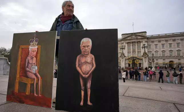 Artist Kaya Mar sposes with the newest edition of his paintings for the media in front of Buckingham Palace, London, Friday, Feb. 20, 2026 after Andrew Mountbatten-Windsor was arrested and held for hours by British police on suspicion of misconduct in public office related to his links to Jeffrey Epstein.(AP Photo/Kin Cheung)