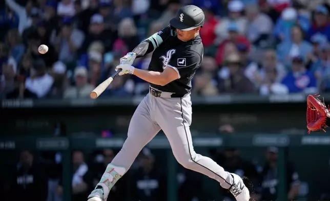 Chicago White Sox's Munetaka Murakami, of Japan, connects for a two-run double against the Chicago Cubs during the fourth inning of a spring training baseball game Friday, Feb. 20, 2026, in Mesa, Ariz. (AP Photo/Ross D. Franklin)