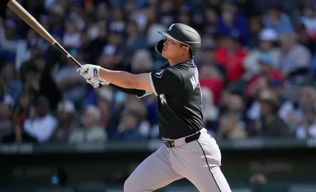 Chicago White Sox's Munetaka Murakami, of Japan, watches the flight of his two-run double against the Chicago Cubs during the fourth inning of a spring training baseball game Friday, Feb. 20, 2026, in Mesa, Ariz. (AP Photo/Ross D. Franklin)