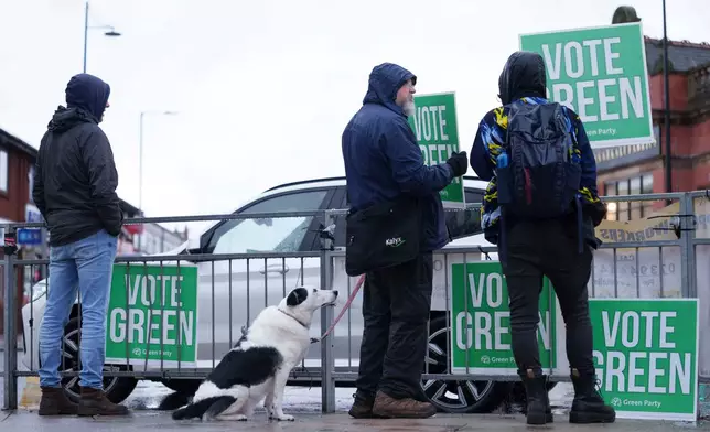 Green Party supporters in Levenshulme in northwest England, Thursday Feb. 26, 2026, as voters head to the polls in the Gorton and Denton constituency. (AP Photo/Jon Super)