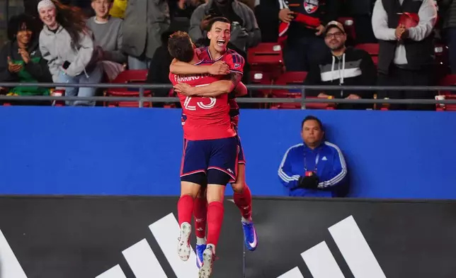 FC Dallas forward Logan Farrington (23) celebrates after his goal with teammate forward Petar Musa, center right, during the first half of an MLS soccer match against Toronto FC in Frisco, Texas, Saturday, Feb. 21, 2026. (AP Photo/LM Otero)