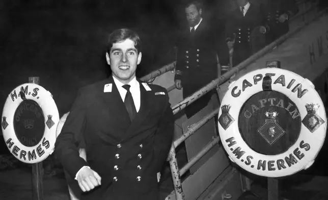FILE- Prince Andrew strides along the dock at Pensacola Naval Base in Pensacola, Florida on Feb. 23, 1980 as he prepares for shore leave. Prince Andrews is stationed aboard the HMS Hermes and undergoing training at the facility. (AP Photo/MB, File)