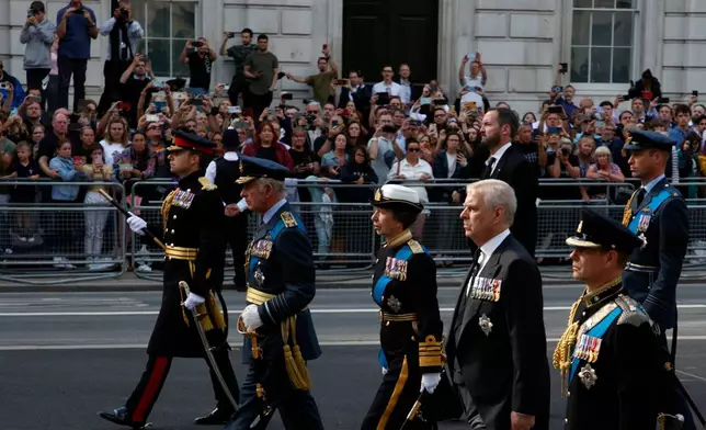 FILE - Britain's King Charles III, second left, Princess Anne, third right, Prince Andrew, second right, followed by Prince William, and Prince Harry, unseen, follow the coffin of Queen Elizabeth II during a procession from Buckingham Palace to Westminster Hall in London, Wednesday, Sept.14., 2022. (AP Photo/David Cliff, Pool, File)