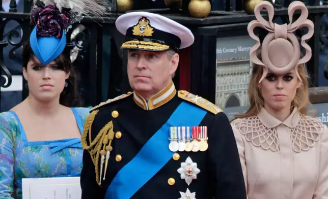 FILE - Britain's Prince Andrew, center, and his daughters Princess Eugenie, left, and Princess Beatrice leave Westminster Abbey after the wedding of Prince William to Catherine Middleton, in London, April 29, 2011. (AP Photo/Gero Breloer, File)
