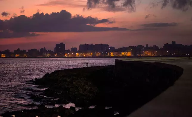 FILE - A fisherman casts his line along the Malecon at sunrise in Havana, Cuba, Wednesday, Oct. 8, 2014. (AP Photo/Ramon Espinosa, File)