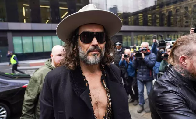 Russell Brand arrives at Southwark Crown Court, in London, Tuesday, Feb. 24, 2026. (AP Photo/Alberto Pezzali)