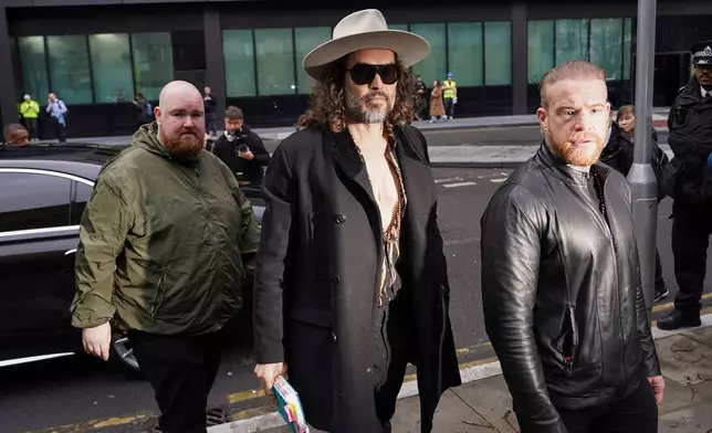 Russell Brand arrives at Southwark Crown Court, in London, Tuesday, Feb. 24, 2026. (AP Photo/Alberto Pezzali)