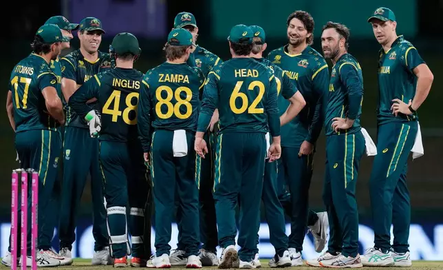 Australia's Glenn Maxwell, second right, celebrates with teammates the wicket of Oman's Jiten Ramanandi during the T20 World Cup cricket match between Australia and Oman in Pallekele, Sri Lanka, Friday, Feb. 20, 2026. (AP Photo/Eranga Jayawardena)