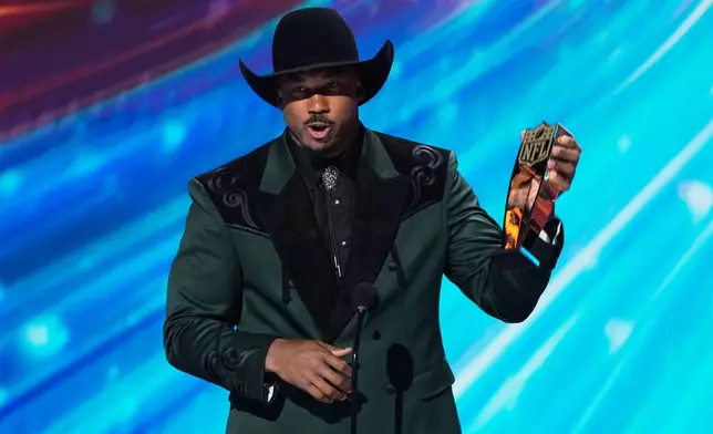 Cleveland Browns' Myles Garrett excepts the AP Defensive Player of the Year award during the NFL Honors award show, Thursday, Feb. 5, 2026, in San Francisco. (AP Photo/Charlie Riedel)