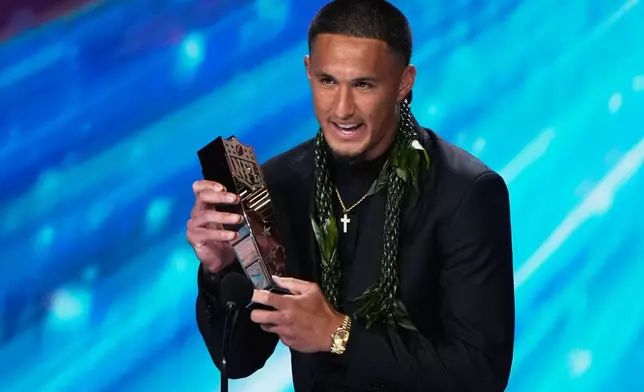 Carolina Panthers' Tetairoa McMillan accepts the AP Offensive Rookie of the Year award during the NFL Honors award show, Thursday, Feb. 5, 2026, in San Francisco. (AP Photo/Charlie Riedel)