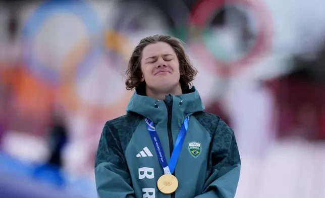 Brazil's Lucas Pinheiro Braathen listens to the national anthem as he wears his gold medal for an alpine ski, men's giant slalom race, at the 2026 Winter Olympics, in Bormio, Italy, Saturday, Feb. 14, 2026.(AP Photo/Julia Demaree Nikhinson)