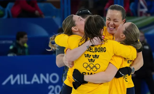 Sweden's Anna Hasselborg, Sara McManus, Sofia Scharback, Agnes Knochenhauer celebrate after winning a women's curling semifinal match against Canada, at the 2026 Winter Olympics, in Cortina d'Ampezzo, Italy, Friday, Feb. 20, 2026. (AP Photo/Misper Apawu)