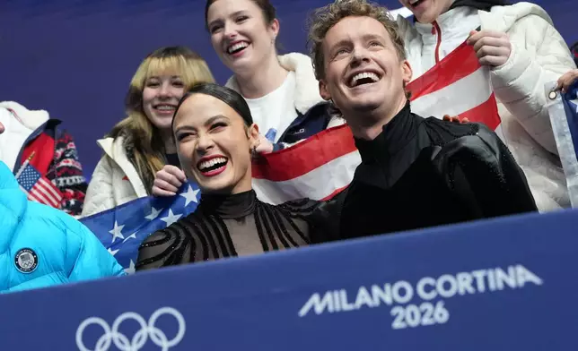 Madison Chock and Evan Bates of the United States react to their scores after competing during the figure skating ice dance team event at the 2026 Winter Olympics, in Milan, Italy, Saturday, Feb. 7, 2026. (AP Photo/Francisco Seco)