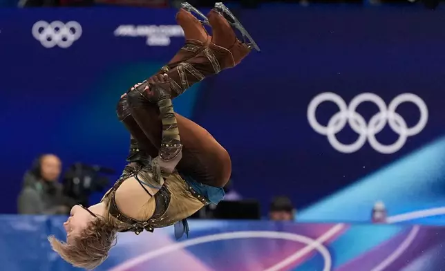 Ilia Malinin of the United States does a back flip while competing during the men's figure skating short program at the 2026 Winter Olympics, in Milan, Italy, Tuesday, Feb. 10, 2026. (AP Photo/Ashley Landis)