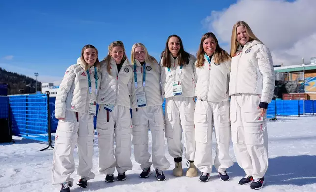 United States cross country athletes, from left, Novie McCabe, Jessie Diggins, Sammy Smith, Julia Kern, Rosie Brennan and Hayiley Swirlbul pose for photos before a cross country training session at the 2026 Winter Olympics, in Tesero, Italy, Thursday, Feb. 5, 2026. (AP Photo/Matthias Schrader)