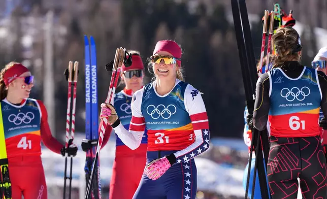 Jessie Diggins, of the United States, smiles after finishing the cross-country skiing women's team sprint free at the 2026 Winter Olympics, in Tesero, Italy, Wednesday, Feb. 18, 2026. (AP Photo/Kirsty Wigglesworth)