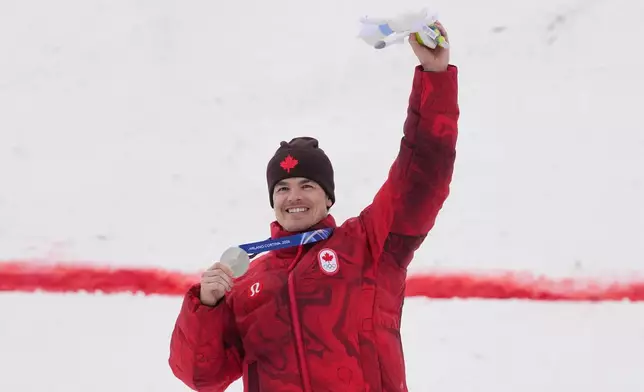 Canada's Mikael Kingsbury celebrates his silver medal in the men's freestyle skiing moguls finals at the 2026 Winter Olympics, in Livigno, Italy, Thursday, Feb. 12, 2026. (AP Photo/Gregory Bull)