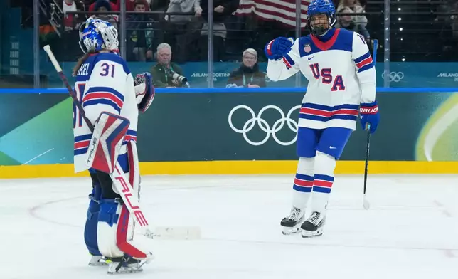 United States' Laila Edwards (10) celebrates a goal with goaltender Aerin Frankel (31) during third period against Canada during the third period of a preliminary round match of women's ice hockey between USA and Canada at the 2026 Winter Olympics in Milan, Italy, Tuesday, Feb. 10, 2026. (Nathan Denette/The Canadian Press via AP)
