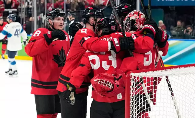 Canada players celebrate at the end of a men's ice hockey semifinal game between Canada and Finland at the 2026 Winter Olympics, in Milan, Italy, Friday, Feb. 20, 2026. (AP Photo/Hassan Ammar)