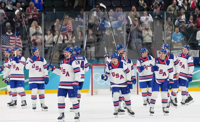 United States players celebrate at the end of a men's ice hockey semifinal game between the United States and Slovakia at the 2026 Winter Olympics, in Milan, Italy, Friday, Feb. 20, 2026. (AP Photo/Hassan Ammar)
