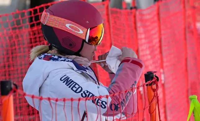 FILE - Mikaela Shiffrin of the United States adjusts her face mask before heading to the gondola to go up the alpine ski course for a training run at the 2022 Winter Olympics, Feb. 10, 2022, in the Yanqing district of Beijing. (AP Photo/Luca Bruno, file)