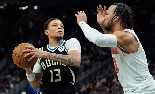 Milwaukee Bucks' Ryan Rollins (13) drives to the basket against New York Knicks' Jalen Brunson, right, during the first half of an NBA basketball game Friday, Feb. 27, 2026, in Milwaukee. (AP Photo/Aaron Gash)
