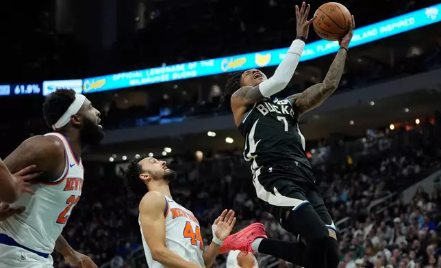 Milwaukee Bucks' Kevin Porter Jr. (7) goes up to shoot over New York Knicks' Landry Shamet (44) during the first half of an NBA basketball game Friday, Feb. 27, 2026, in Milwaukee. (AP Photo/Aaron Gash)