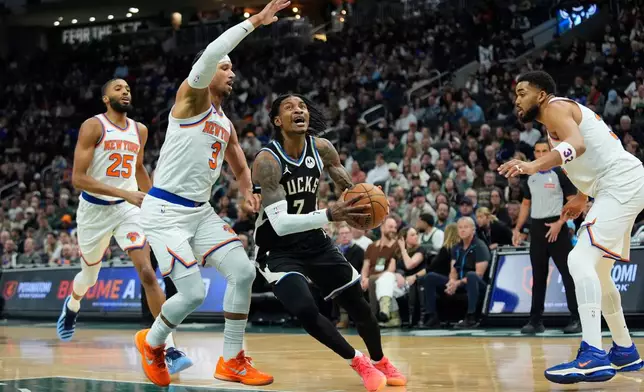 Milwaukee Bucks' Kevin Porter Jr. (7) drives to the basket against New York Knicks' Josh Hart (3) during the first half of an NBA basketball game Friday, Feb. 27, 2026, in Milwaukee. (AP Photo/Aaron Gash)