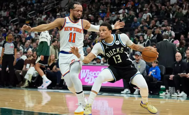 Milwaukee Bucks' Ryan Rollins (13) drives to the basket against New York Knicks' Jalen Brunson (11) during the first half of an NBA basketball game Friday, Feb. 27, 2026, in Milwaukee. (AP Photo/Aaron Gash)