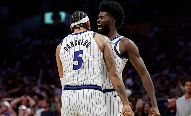 Orlando Magic forward Paolo Banchero (5) and Orlando Magic forward Jonathan Isaac (1) react at the end of the game as the Orlando Magic defeat the Los Angeles Lakers during an NBA basketball game Tuesday, Feb. 24, 2026, in Los Angeles. (AP Photo/Caroline Brehman)