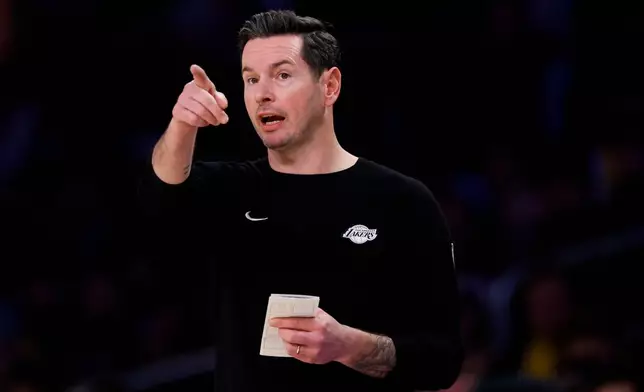 Los Angeles Lakers head coach JJ Redick gestures to players during the first half of an NBA basketball game, Tuesday, Feb. 24, 2026, in Los Angeles. (AP Photo/Caroline Brehman)