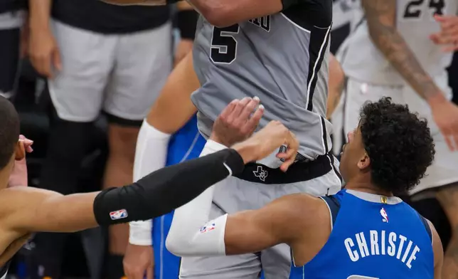 San Antonio Spurs guard Stephon Castle (5) goes to the basket against Dallas Mavericks guard Max Christie (00) during the first half of an NBA basketball game, Saturday, Feb. 7, 2026, in San Antonio. (AP Photo/Darren Abate)