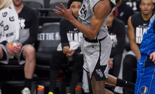 San Antonio Spurs guard Devin Vassell (24) goes to the basket during the first half of an NBA basketball game against the Dallas Mavericks, Saturday, Feb. 7, 2026, in San Antonio. (AP Photo/Darren Abate)
