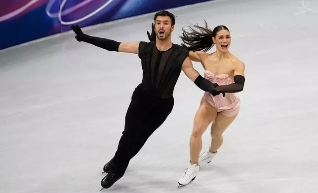 Laurence Fournier Beaudry and Guillaume Cizeron of France compete during the figure skating ice dance team event at the 2026 Winter Olympics, in Milan, Italy, Friday, Feb. 6, 2026. (AP Photo/Ashley Landis)