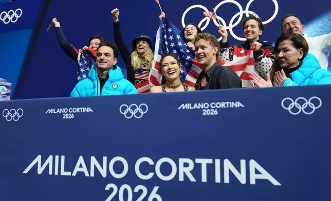 Madison Chock and Evan Bates of the United States react to their scores after competing during the figure skating ice dance team event at the 2026 Winter Olympics, in Milan, Italy, Friday, Feb. 6, 2026. (AP Photo/Stephanie Scarbrough)